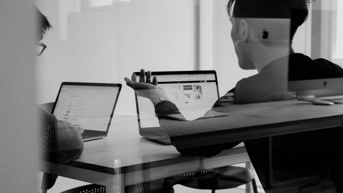 Two guys with laptops in a meeting room